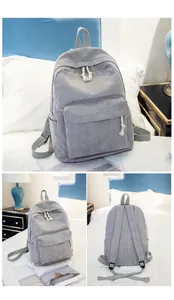 Detail view of light grey corduroy backpack with sturdy zippers and textured fabric