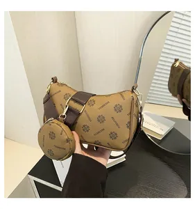 Detail of vintage brown printed crossbody bag with wide strap and matching round coin purse