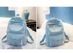 Detail view of light blue corduroy backpack with cotton rope zipper pulls and side pocket