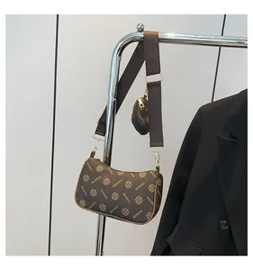 Detail of vintage patterned crossbody bag with wide strap and matching round coin purse