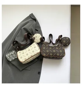 Detail of vintage print crossbody bag with adjustable wide strap and round coin purse