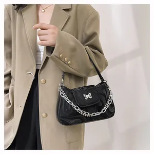 Fashionable black underarm bag with silver butterfly metal detail and dual chain strap
