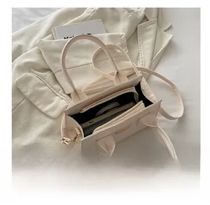 Top view of the spacious inner compartment of this chic off-white stone pattern handbag