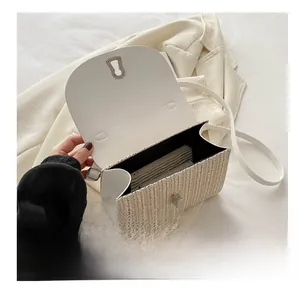 Internal view of the straw crossbody bag showing its spacious capacity for a wallet