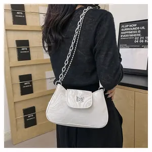 Detail of marble texture shoulder bag with silver butterfly buckle and metal chain strap