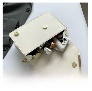Top view of cream white chain bag interior showing space for phone and makeup