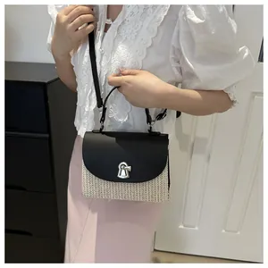 Straw shoulder bag worn with white lace shirt and pink skirt in home setting