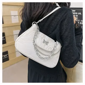 Detail of marble pattern baguette bag featuring a silver metal butterfly buckle and chain