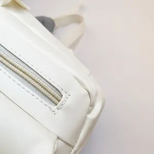 Macro shot of high-quality white PU leather texture and neat zipper stitching details