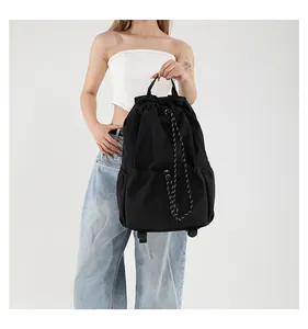 Vue détaillée du sac à dos noir en nylon avec cordon de serrage et bretelles réglables