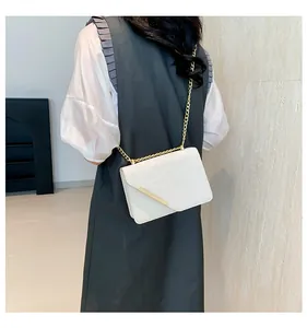 Chic white small square bag with gold chain strap shown on model for size and fit