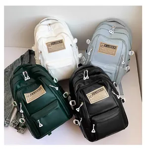 Detailed macro view showing diverse color options and minimalist fashion labels on soft PU backpacks