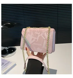 Pink chain handbag with textured geometric patterns and gold-tone metal hardware