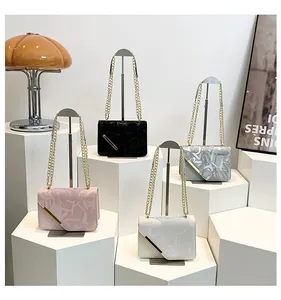 Detail of elegant chain strap and geometric metal buckle on four stylish square bags