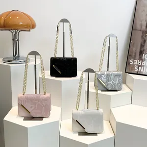Chic textured chain bags with diagonal gold bars in pink, black, grey, and white colors