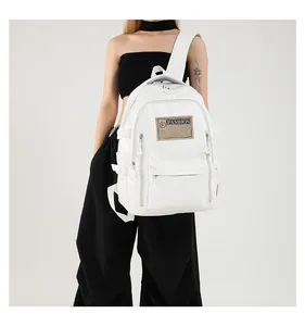 Detail of white PU leather backpack featuring brown fashion patch and side buckles