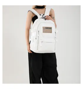 Detail view of white PU leather backpack featuring side buckles and fashion label