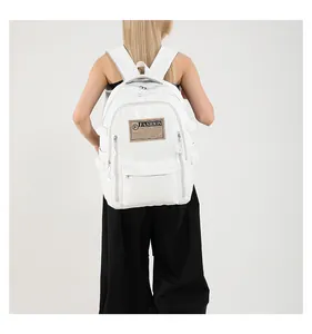 Rear view of a white large capacity PU leather backpack with FASHION patch on a model