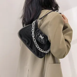 Black marble texture shoulder bag with silver butterfly buckle and metal chain detail