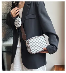 Detail of printed crossbody bag set with wide strap and mini round coin purse