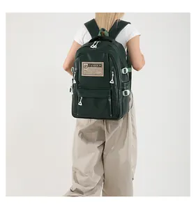 Detail of dark green PU leather backpack with adjustable side buckles and fashion patch