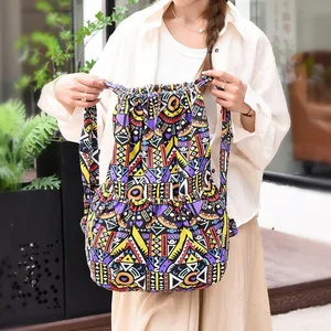 Detail of colorful geometric tribal patterns and side pockets on the canvas drawstring backpack