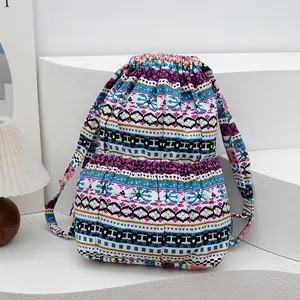 Close-up of drawstring closure and ethnic geometric weave pattern on canvas backpack