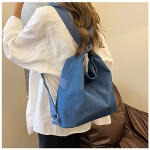 Blue denim multi-way backpack for women showing back view and wide shoulder straps