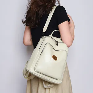 Large cream faux leather backpack for women featuring stitching detail and metal logo plate