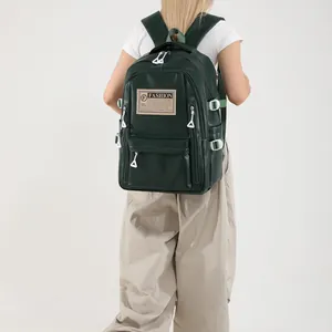 Dark green matte PU leather backpack featuring large capacity and stylish white accents