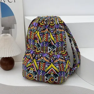 Close-up of ethnic bucket backpack showing the drawstring closure and side pocket