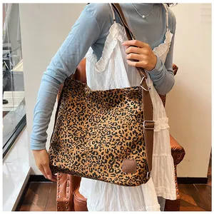 Detail view of large leopard print canvas tote bag with adjustable shoulder strap
