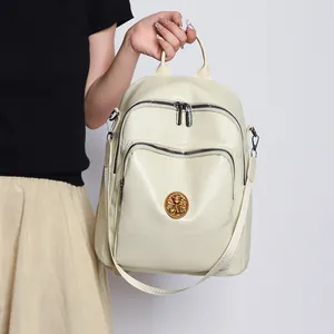 Large capacity beige multi-way faux leather backpack with vintage gold metal emblem