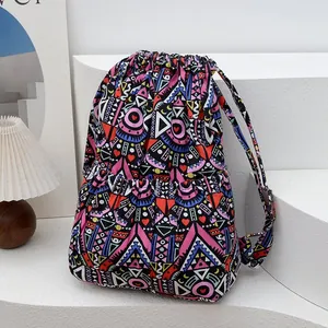 Detailed close-up of bohemian striped canvas backpack with drawstring closure and tribal patterns