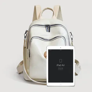 Large capacity beige faux leather backpack with geometric texture and iPad for size scale