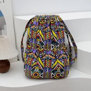 Detailed close-up of ethnic geometric pattern fabric and drawstring on the boho backpack