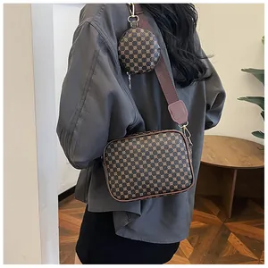 Detail of vintage geometric pattern cross-body bag with wide strap and round coin pouch