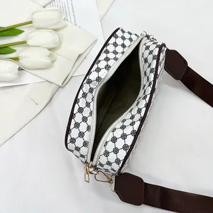 Detail view of the clover pattern shoulder bag with interior lining and wide strap