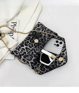 Detailed view of leopard print clutch interior with gold magnetic snap and chain strap