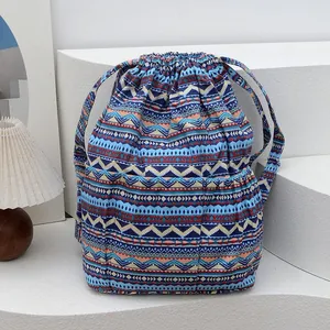 Detail of bohemian striped drawstring backpack featuring colorful geometric canvas texture