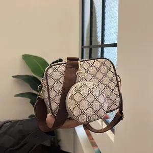 Vintage patterned crossbody bag with wide shoulder strap and mini round coin pouch