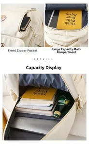 Detail of cream nylon backpack showing front zipper pocket and large capacity main compartment