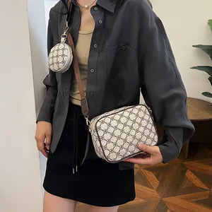 Detail view of cream vintage crossbody bag with geometric pattern and wide strap