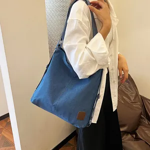 Blue canvas large capacity tote bag with adjustable shoulder strap for women's crossbody use