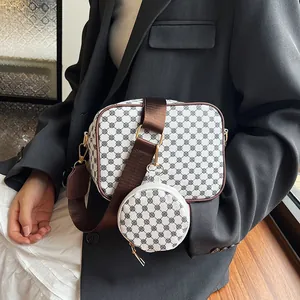 Detail of crossbody bag set with wide shoulder strap and round mini coin purse pouch