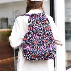Detailed back view of a colorful ethnic drawstring backpack with geometric canvas patterns