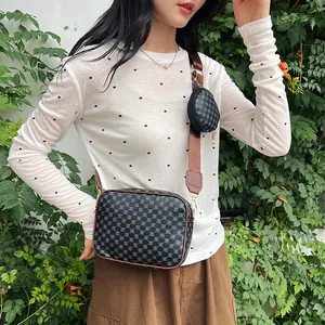 Detail of crossbody square bag with wide strap and small round coin purse attachment