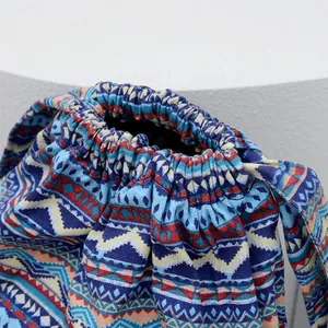 Close-up of bohemian drawstring backpack showing geometric patterns and canvas texture