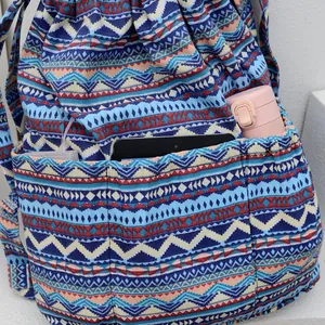 Detail of bohemian canvas drawstring backpack showing multiple front storage pockets