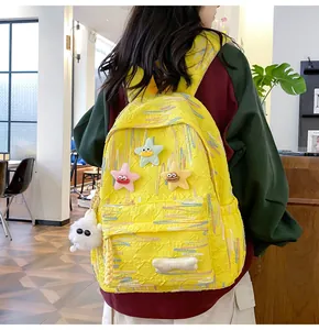 Detail of yellow aesthetic backpack with plush stars and embroidered texture in a cafe